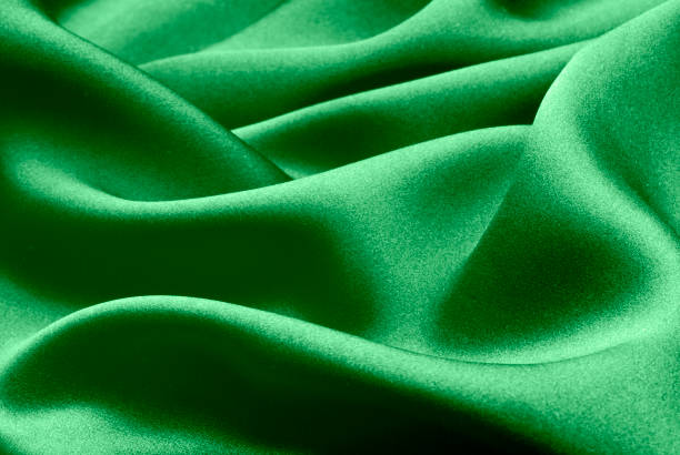 istock green silk forming elegant waves with shadows and chiaroscuro, background of textile material 1396520300