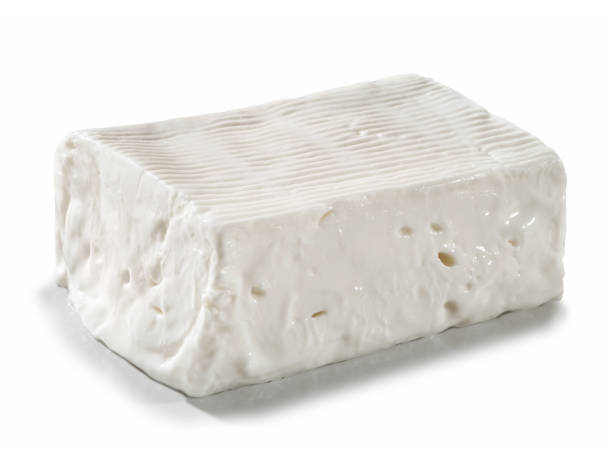 large portion of soft and spreadable fresh cheese, placed on a white surface