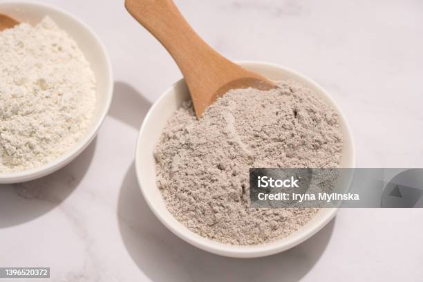Closeup View Of Gray And White Cosmetic Clay On White Marble Table Mineral Powder Bentonite Facial Mask Skincare Beauty Concept Top View Stock Photo - Download Image Now