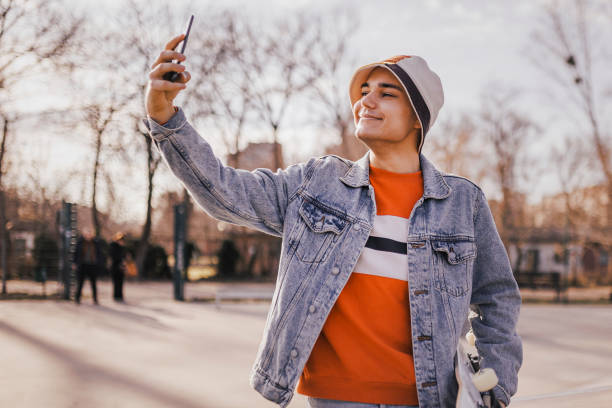 istock Skateboarder having video call at skateboard park 1396521473