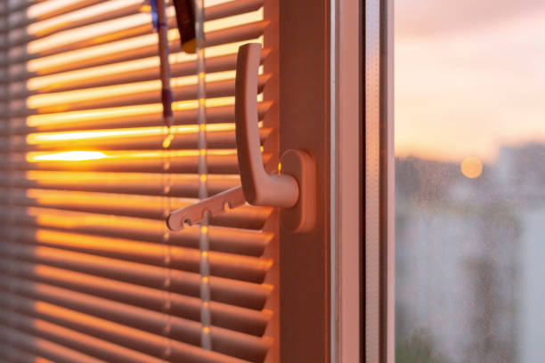 istock Evening sun light outside window blinds, sunshine and shadow on window 1396524721