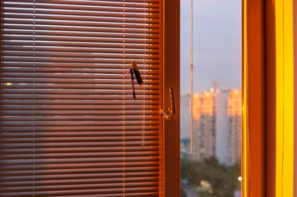 istock Evening sun light outside window blinds, sunshine and shadow on window. 1396524777