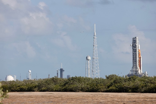 Titusville, FL., USA - April 11, 2022: Artemis 1 rocket capped with Orion crew capsule on launch pad 39B in preparation for prelaunch testing at NASA’s Kennedy Space Center in mid afternoon sun.  Shimmering distant image due to heat haze.