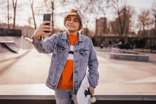 istock Skateboarder having video call at skateboard park 1396525036