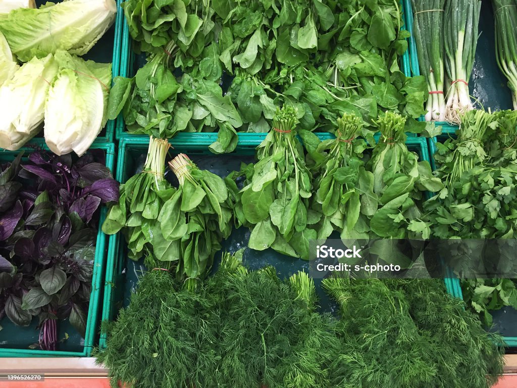 Fresh organic leaf vegetables on the market stall Leaf Vegetable Stock Photo