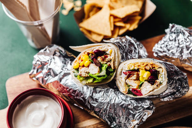 Mexican Burrito with tomato salad and guacamole dip