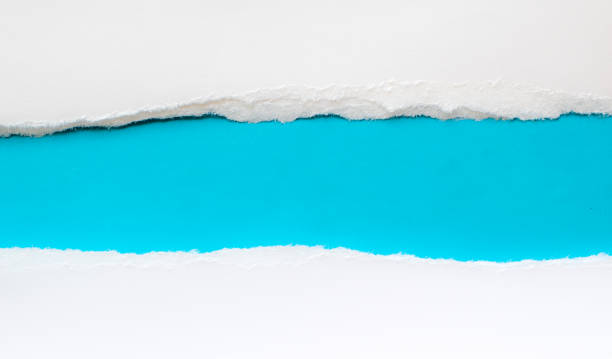 istock pieces of torn paper on a blue background. copy space 1396527676