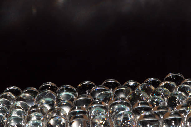 istock abstract black background with transparent 3d glass beads, copy space, elegant design 1396530579