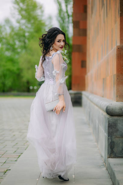 istock Back view of adorable bridesmaid walking and looking back at camera 1396530832