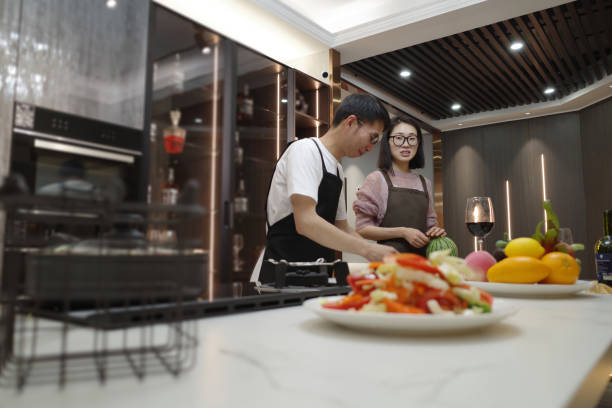 istock Husband and wife make vegetable salad in the kitchen 1396534405