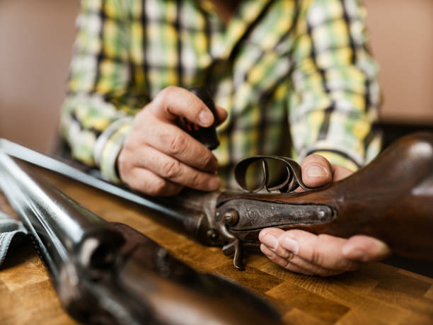 Hands of a man holding an unloaded pistol
