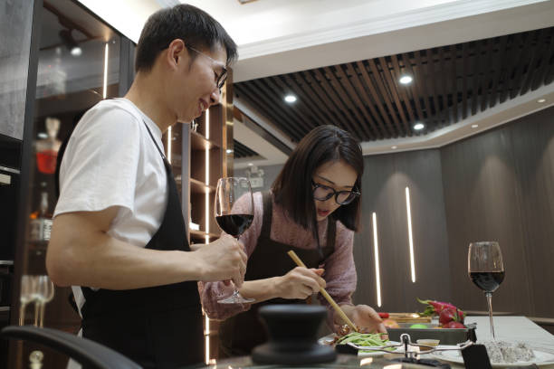 istock Husband and wife prepare red wine dinner in the kitchen 1396534488
