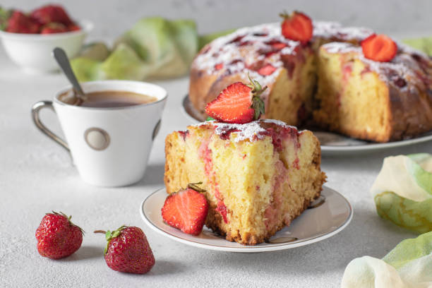 istock Charlotte pie strawberries with a cut piece and also cup of coffee on a gray table 1396536865