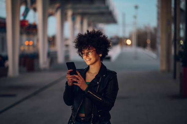istock Woman waiting on a train station platform and using smartphone 1396538039