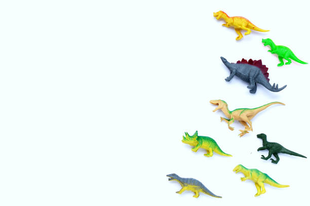 istock Plastic dinosaur toys on white background. Top view 1396539767