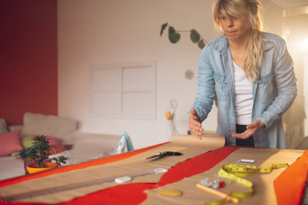 istock Woman tailor working from home and tailoring beautiful clothes 1396539821