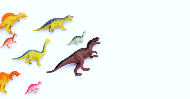istock Plastic dinosaur toys on white background. Top view 1396541590