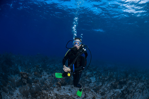 Diving instructor and students. Instructor teaches students to dive in the swimming pool.