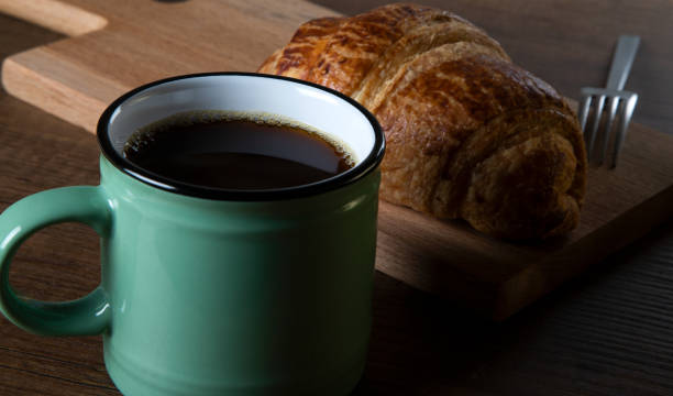 istock Croissant with a cup of full coffee ,directly above 1396548079