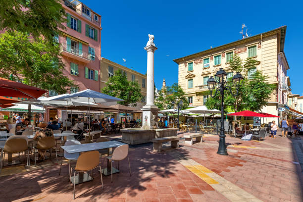 Small town square with outdoor restaurants in Menton, France. stock photo