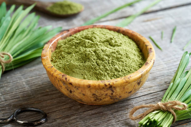 istock Barley grass powder with fresh barley grass plant 1396548291