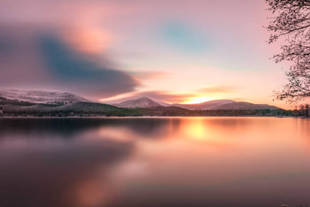 Loch Morlich, Aviemore on beautiful sunset sunrise while calm Loch Morlich, Aviemore on beautiful sunset sunrise day while calm cairngorm mountains stock pictures, royalty-free photos & images