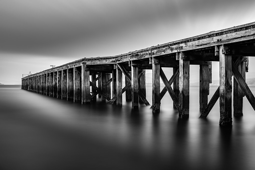 Long Exposure Monochrome Image of Lamonts Pier in Newark, Port Glasgow, Scotland which is historic and rotting.