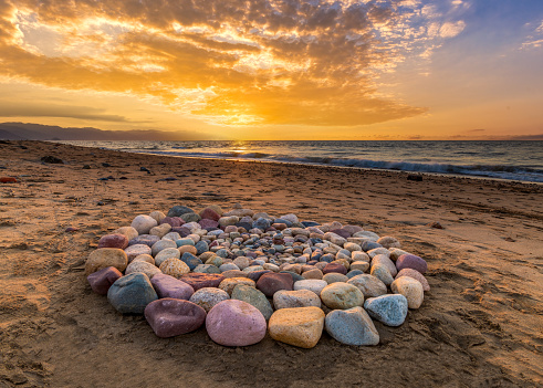 Sacred Ritual Stones For Spiritual Ceremony Are Are Arranged In A Circle During Sunset On The Beach