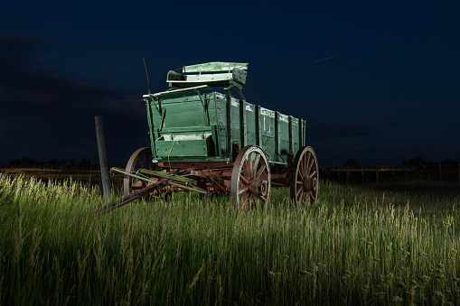 An old carriage  sits in a field in rural South Dakota. in United States, South Dakota, Custer