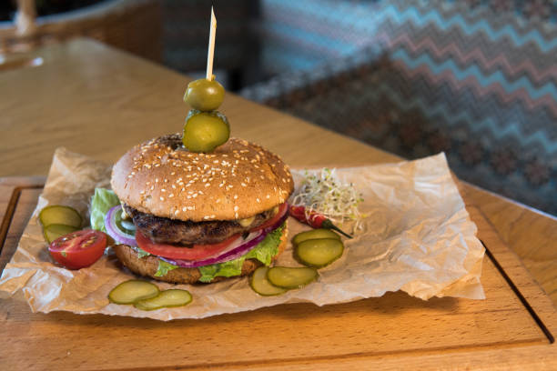 istock A burger with veal, lettuce leaves, tomatoes and pickles 1396554140