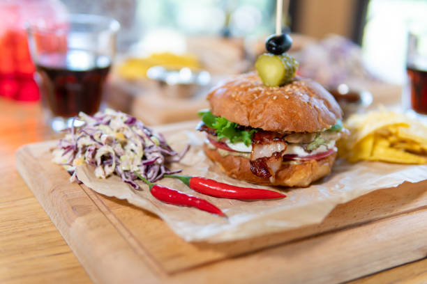 istock Beef patty burger. bacon, cheese, tomato, greens, pickle 1396554159