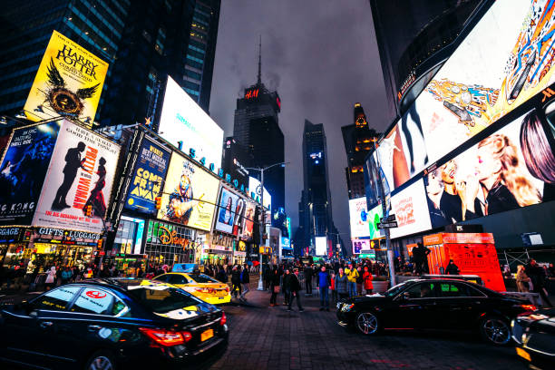times square traffic by night, new york city - new york city times square crowd people imagens e fotografias de stock