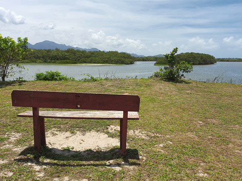 Bench in front of the Ararapira channel that separates the states of São Paulo and Paraná in Brazil