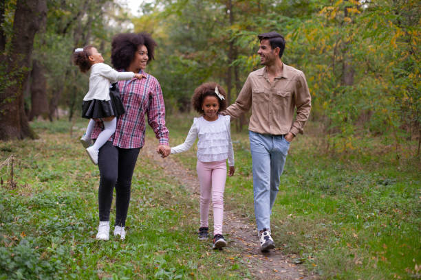 istock Happy family walking along a path in the woods 1396566988