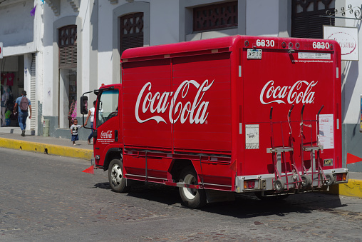 Puerto Vallarta, Nayarit, Mexico - April 21, 2022: image of a Coca Cola delivery truck shown driving in town.