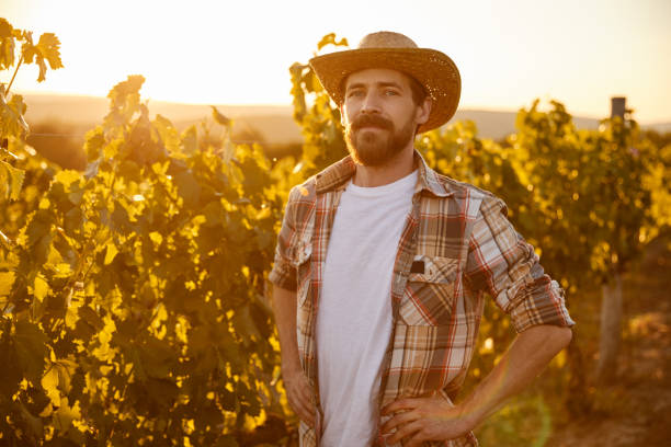 istock Happy farmer standing in vineyard 1396569832