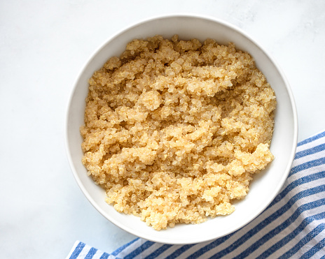 Bowl of Boiled Quinoa seeds on white background