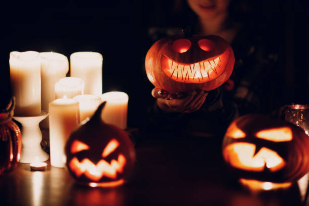 istock Making Halloween pumpkin Jack-o-lantern. Pumkins and candles on table 1396572035