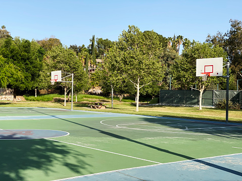 a public park playground basketball court empty courts hoops play sports community public playing