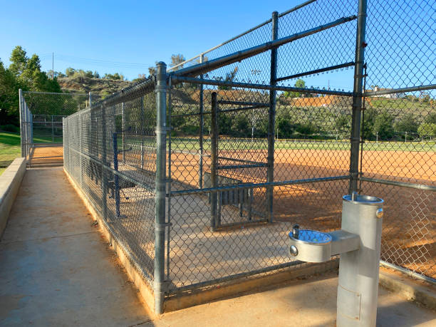 dugout baseball field chain link fence practice playground empty ballpark sports park drinking water fountain a dugout baseball field chain link fence practice playground empty ballpark sports park drinking water fountain baseball cage stock pictures, royalty-free photos & images