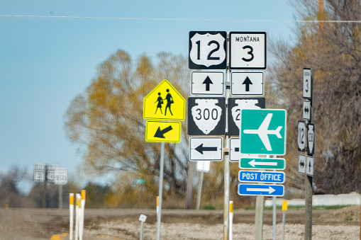 Street and highway information signs at intersection in Montana in northwestern United States of America (USA).