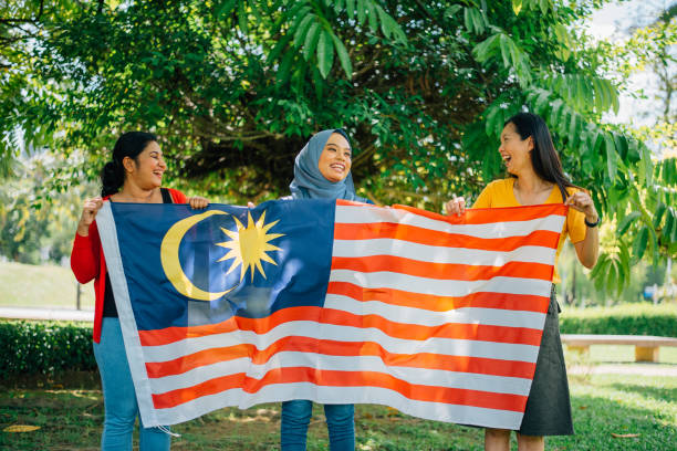 istock Malaysian multi-ethnic group people with Malaysian flag celebrating independence day 1396584247