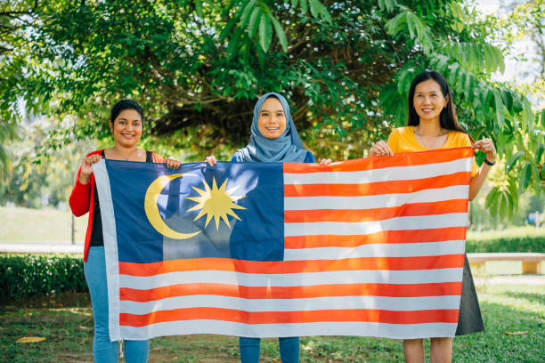 istock Malaysian multi-ethnic group people with Malaysian flag celebrating independence day 1396584249