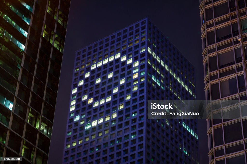 Happy face shape in lights in downtown district office business buildings at night Happy face shape in lights in downtown district office business buildings at night, digital composite Anthropomorphic Smiley Face Stock Photo