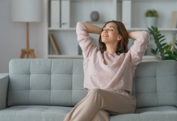 istock woman resting on a sofa 1396585146