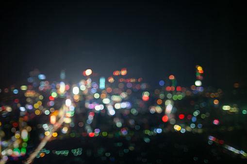 Night view cityscape of urban center multi-colored lights defocused background