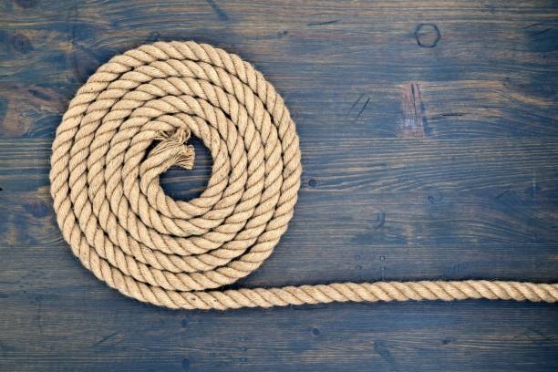 istock Braided natural jute rope over a rustic wood 1396586824