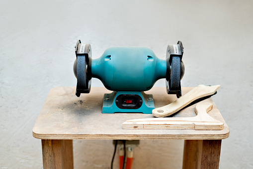 Bench grinder for polishing wood in a carpentry workshop.