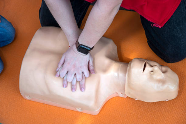 istock Woman doing CPR on a mannequin for training. Direct heart massage. First aid training on medical dummy. heart massage in cardiac arrest 1396589855