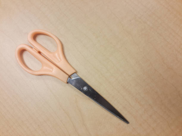 istock The scissors on the table. Shot from above, Top view. 1396589999